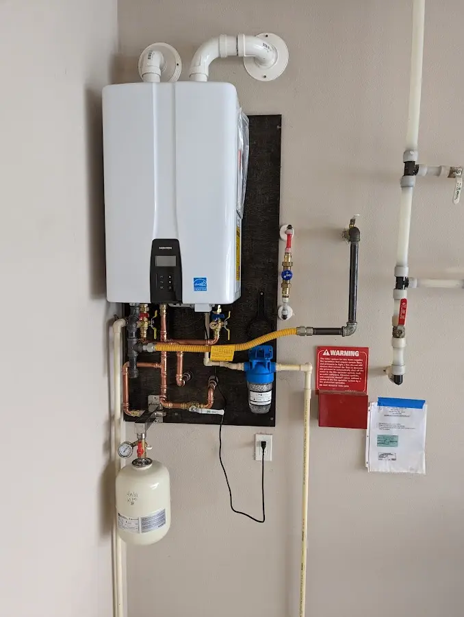 Professional plumber installing copper piping in a Madison home